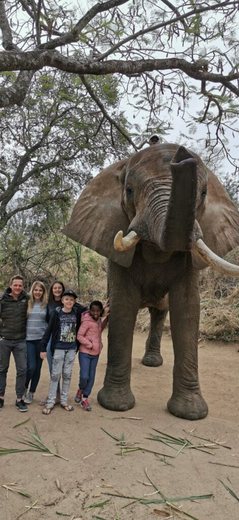 Mia as a young girl with her family beside an elephant in the bush